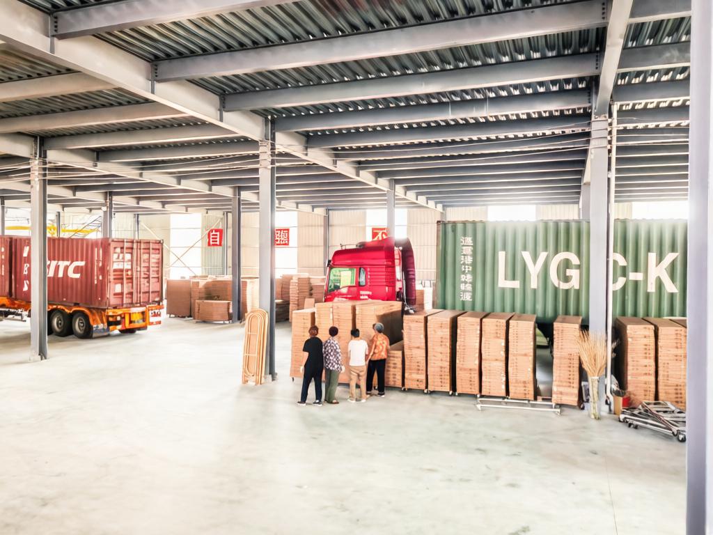 WovenNatural factory workers loading woven home decor products into shipping containers for export to global markets