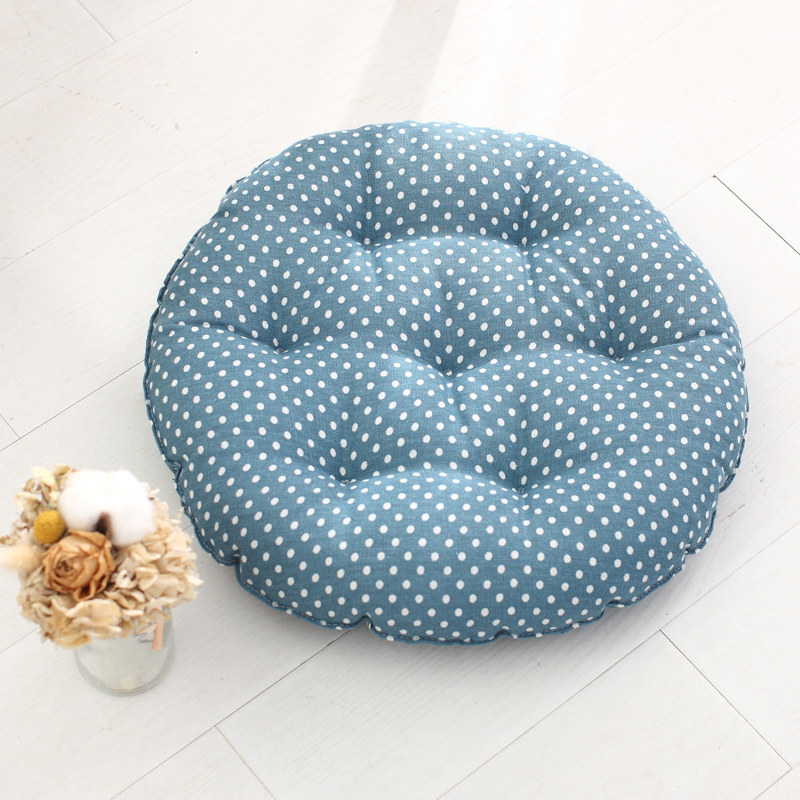 Round tufted cushion with blue base white polka dot printed fabric cover for accommodation interior matching