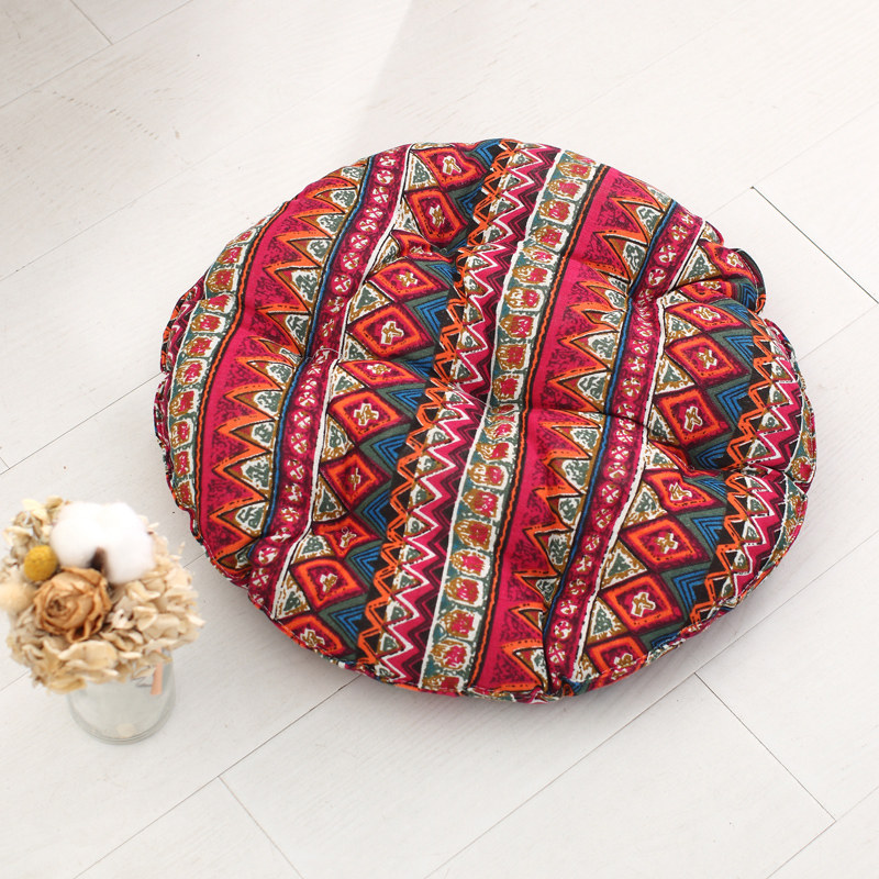 Round tufted cushion with vintage ethnic geometric patterned fabric cover for themed hotel and boutique homestay decor