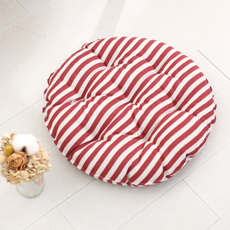 Round tufted cushion with classic red and white stripe woven fabric cover for hotel public areas and guest suites