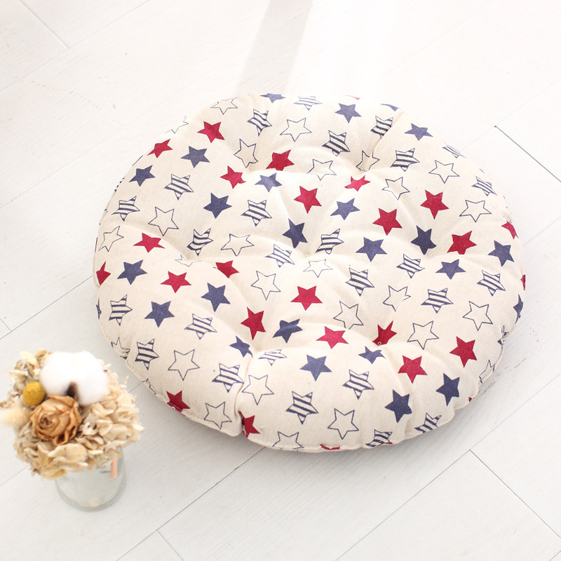 Round tufted cushion decorated with red blue star print fabric cover, ideal for resort and homestay room layout
