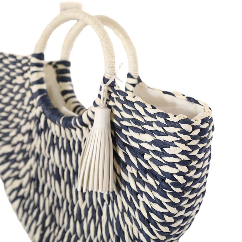 Semicircular navy white striped straw tote bag with white tassel ornament