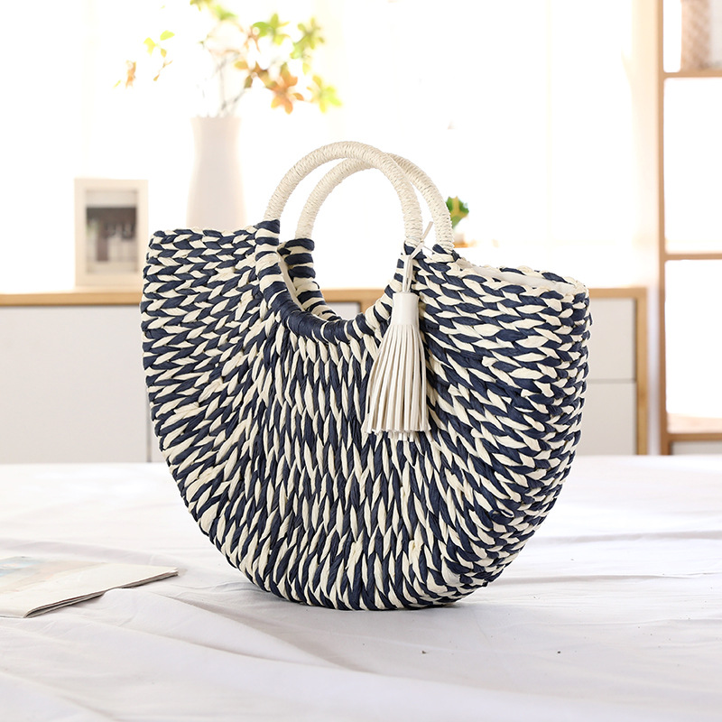 Navy and white interlaced texture of straw tote bag handle and body