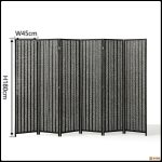 Narrow bamboo folding screen used to screen a doorway in a home interior