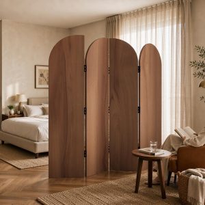 Tall walnut arched room divider panels dividing a suite bedroom from a reading corner with leather armchair