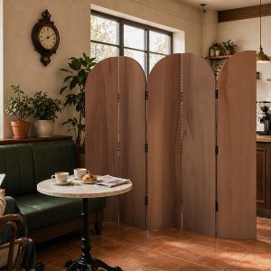 Five arched folding screen panels in striped grain curving around a cafe service counter and pastry case