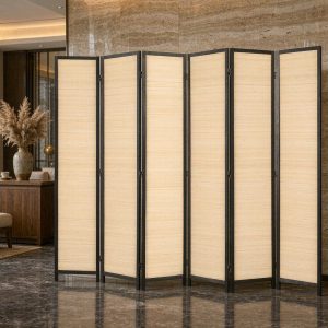Tall black framed bamboo screen panels standing on polished marble in a hotel lobby lounge