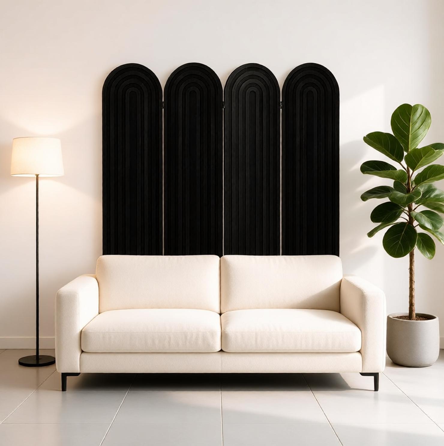 Ridged black arch room divider leaning as a headboard above a cream minimalist sofa in a lounge