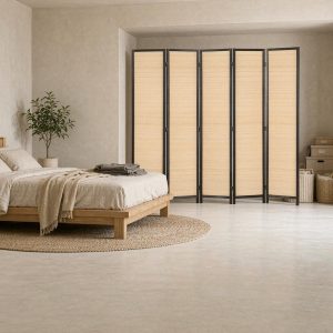 Black framed bamboo room divider panels closing off a bedroom alcove behind a low platform bed