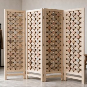 Recessed square tiles of a mosaic block screen with shadow gaps beside a garment rail in a minimalist studio