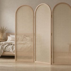 Light oak arched rattan screen with woven cane inserts beside a low wooden bed in a bedroom room
