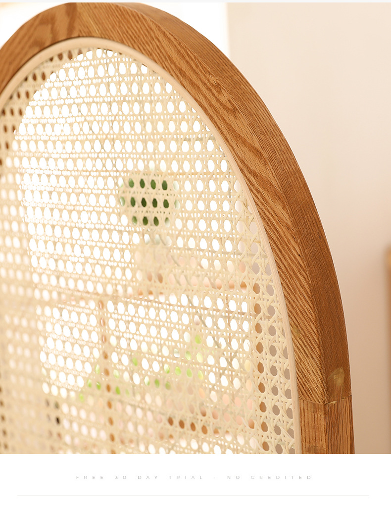 Macro detail of woven natural cane webbing set into an arched solid wood screen frame panel