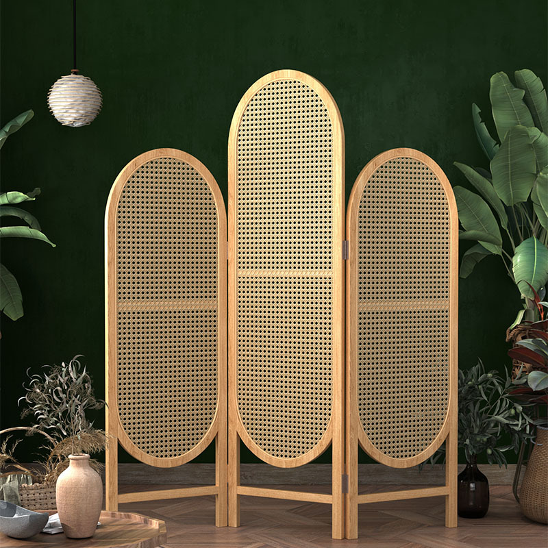Warm cane tone rattan screen ovals filtering sunlight over cream upholstery in a bright living room