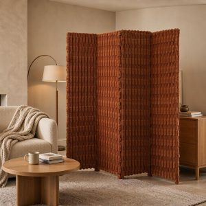 Terracotta screen ribs catching firelight beside neutral sofas and wool throws in a lounge