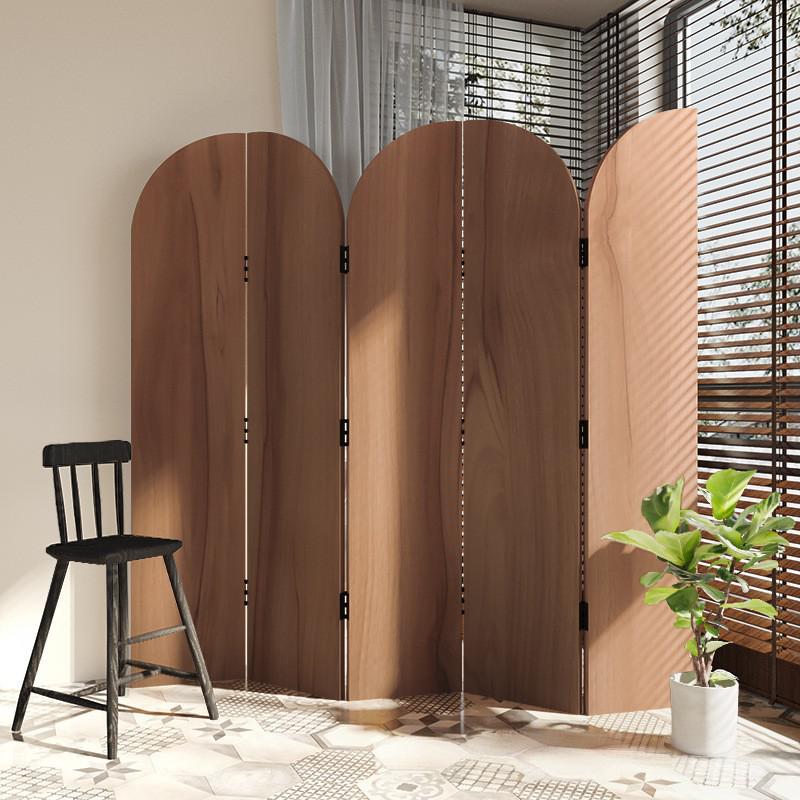 Rounded arch top screen panels standing against a shuttered sunroom window beside a potted plant