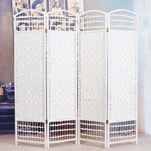 Black woven willow room divider in a classic room with white wall panelling, a gilt sconce and an oil painting
