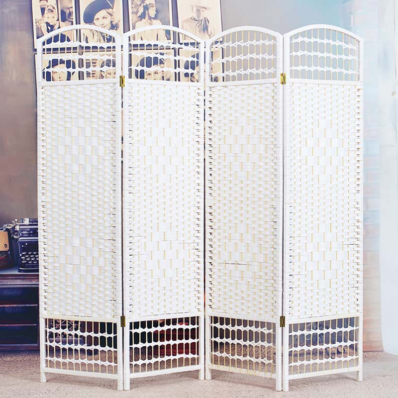 Black woven willow room divider in a classic room with white wall panelling, a gilt sconce and an oil painting