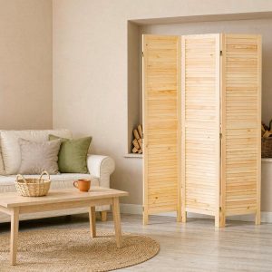 Three louvered screen panels masking firewood storage in a living room alcove beside a sofa