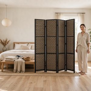 Brick pattern woven screen in a black frame dividing a bright bedroom with soft textiles
