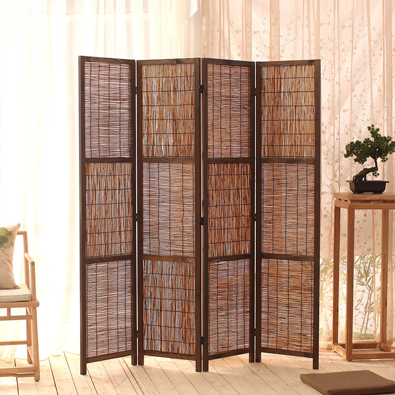 Woven reed screen in a bright living room beside sheer curtains, a bonsai and a rattan side table on wood floor